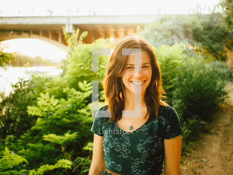 smiling woman standing outdoors 