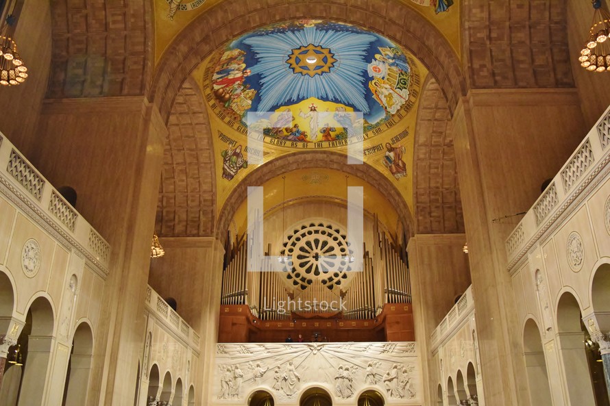 organ pipes and painting on a dome ceiling 