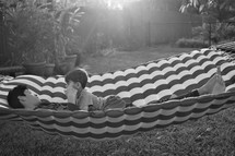 father and son lying in a hammock 
