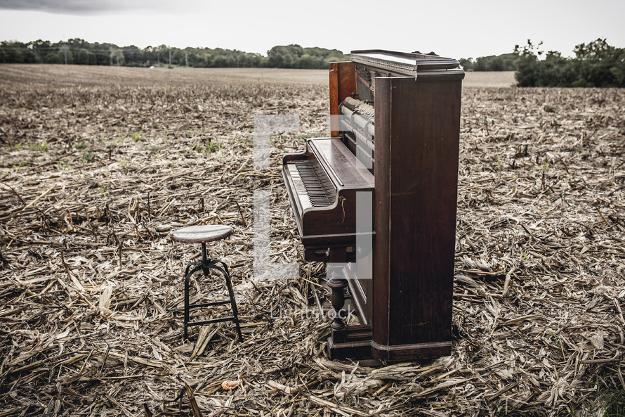 a piano in a plowed field 