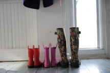 rain boots on a mudroom floor 