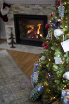 presents under a Christmas tree and fireplace 