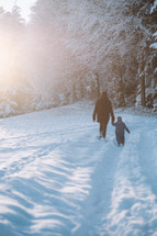 Father and son go for a walk in the snow