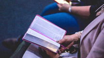 couple reading Bibles together in a church setting 