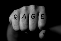 The word RAGE written on a fist. 
