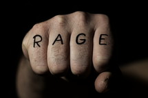 The word RAGE written on a fist