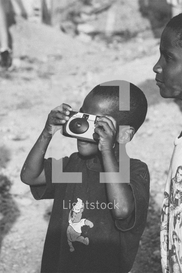 child taking a photograph 