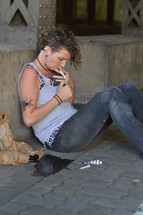 a homeless woman getting high with drugs 