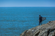 a surfer on a cliff 