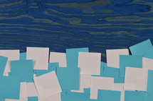 border of blue and white notepads on a blue wooden board