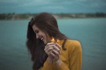 teen girl holding sparklers 