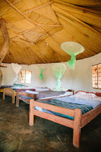 mosquito nets hanging over beds 
