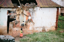 children climbing over a crumbling wall 