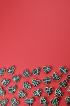 border out of home made heart shaped cookies with chocolate on red background