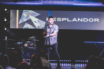 worship leader on stage with a microphone 