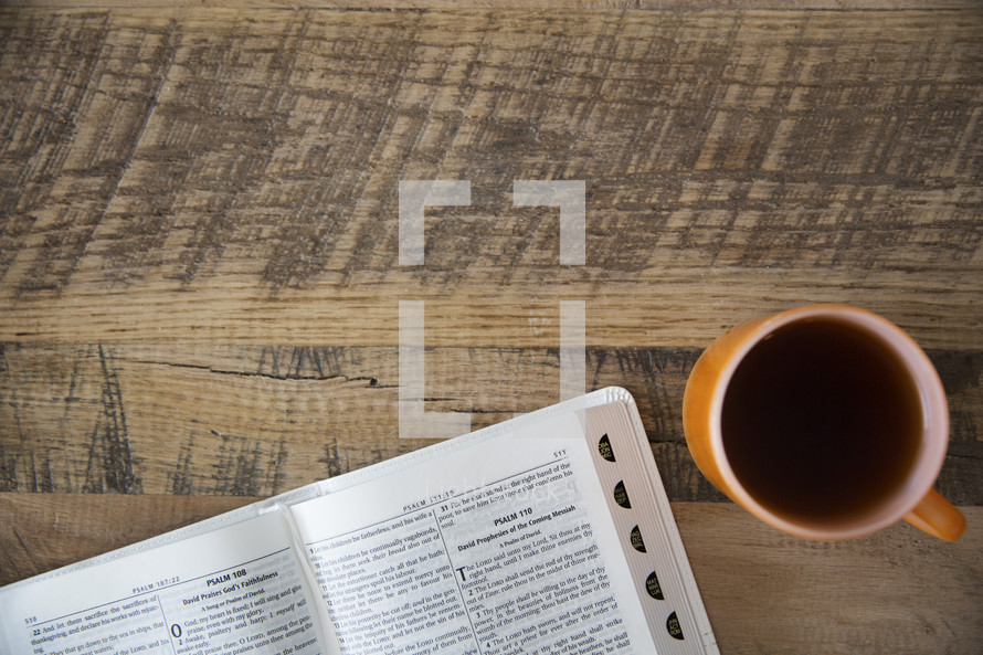 pages of a Bible and coffee mug 