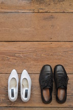 wedding shoes next to each other facing the same direction. 

