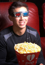 a man watching a movie with 3D glasses 