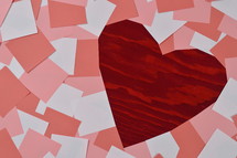 pile of blank rose, antique pink and white notepads showing a part of the red wooden background in the shape of a heart 