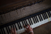 hands on the keys of a piano 