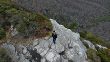 a man standing at the edge of a cliff 
