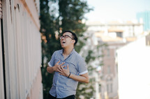 a man laughing outdoors 