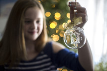 girl decorating a Christmas tree 