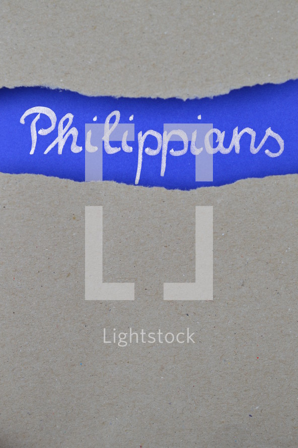 Philippians - torn open kraft paper over intense blue paper with the name of the letter from Paul to the Philippians