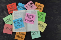 open Bible, spread the gospel, build the kingdom, testify, pray, confession, love your neighbor, repent, worship, thank him, repent, evangelize, praise, obey, words, paper, lettering 
