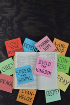 open Bible, spread the gospel, build the kingdom, testify, pray, confession, love your neighbor, repent, worship, thank him, repent, evangelize, praise, obey, words, paper, lettering 