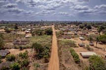 Red dirt road down running through a Village in The Ivory Coast of West Africa