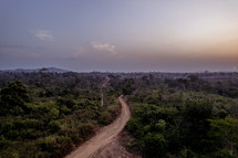 Sunset over the jungle in The Ivory Coast of West Africa with a dirt road