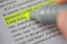 A Highlighter Marker on newspaper News about coronavirus disease COVID 19