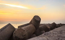 concrete pilings on a beach 