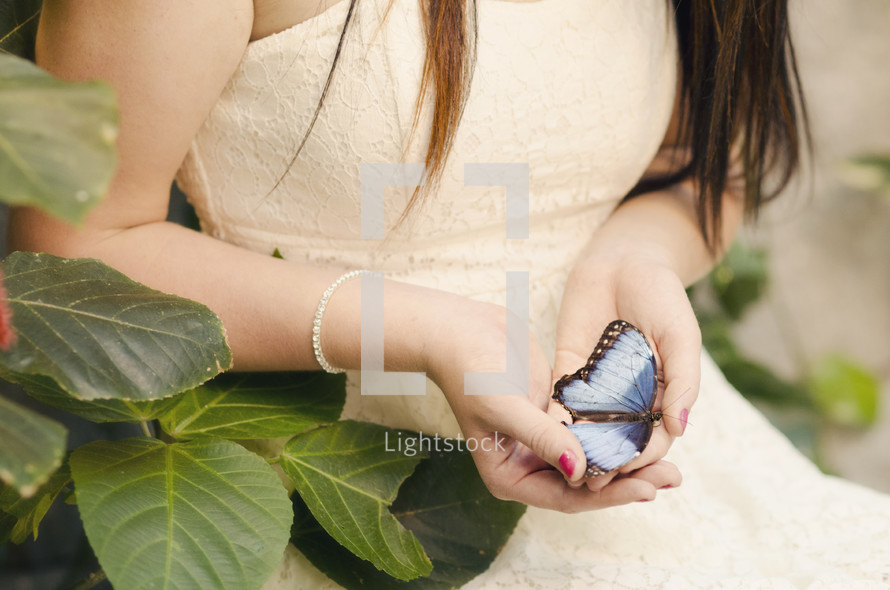 woman holding a butterfly