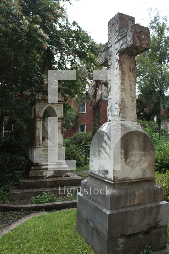 stone cross monument in a cemetery 