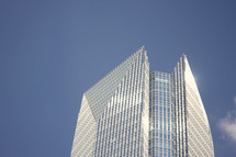 top of a skyscraper in a blue sky 