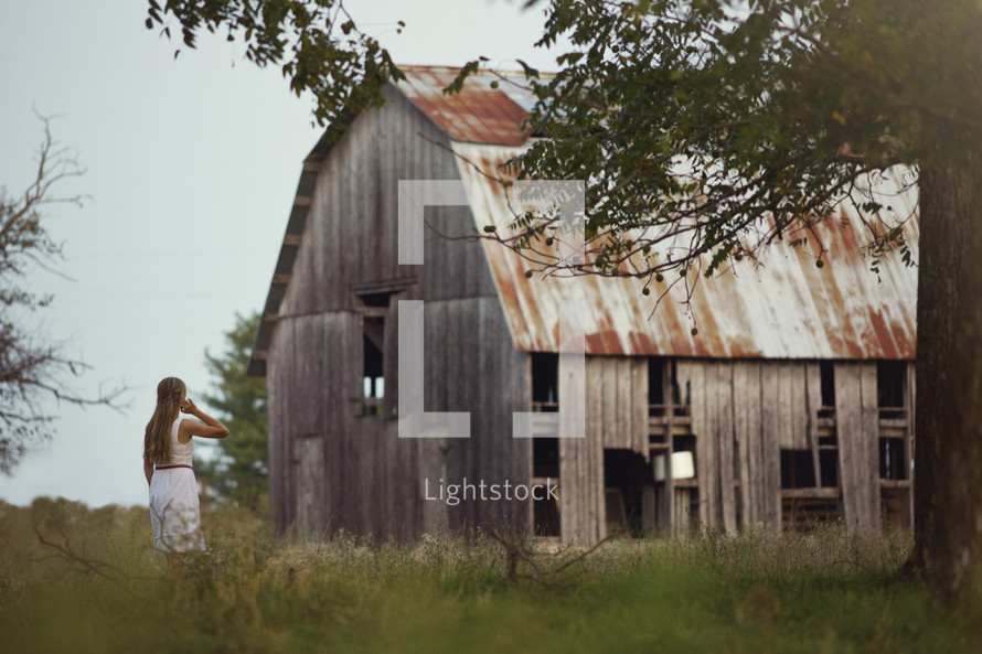 woman and an old weathered barn 