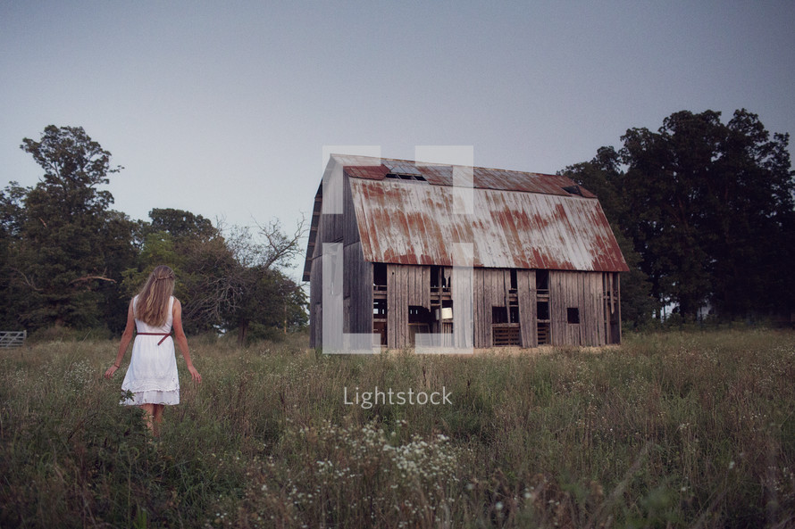 woman and an abandoned barn 