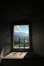 view of mountains through a window opening 