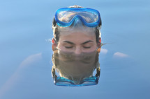 a woman in a pool wearing goggles 
