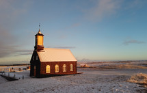 Hvalsneskirkja church located near the village of Sandgerdi in Iceland in winter at sunset