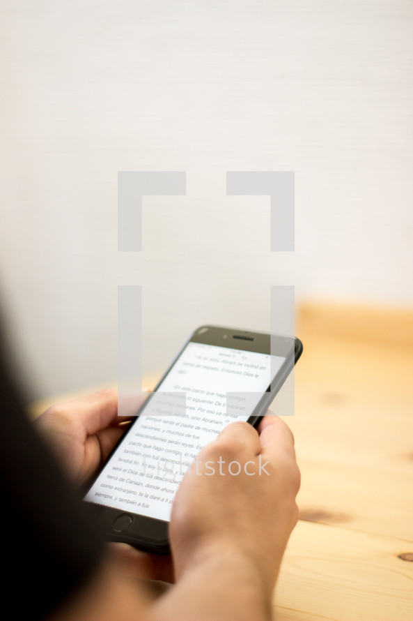 a man reading a Bible app on his cellphone 