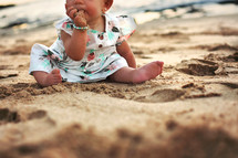 infant girl on a beach 