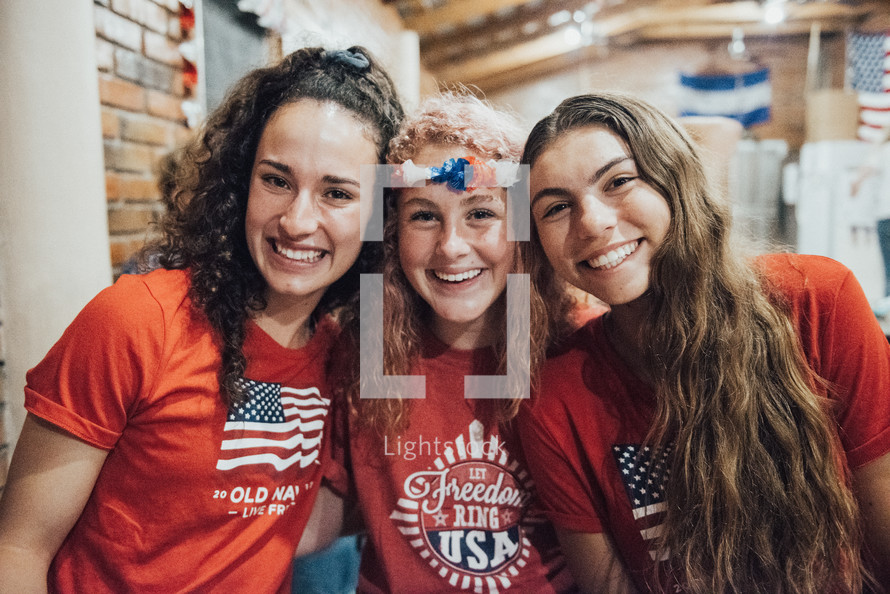 smiling teen girls in patriotic t-shirts 