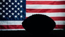 American flag with shadow of football