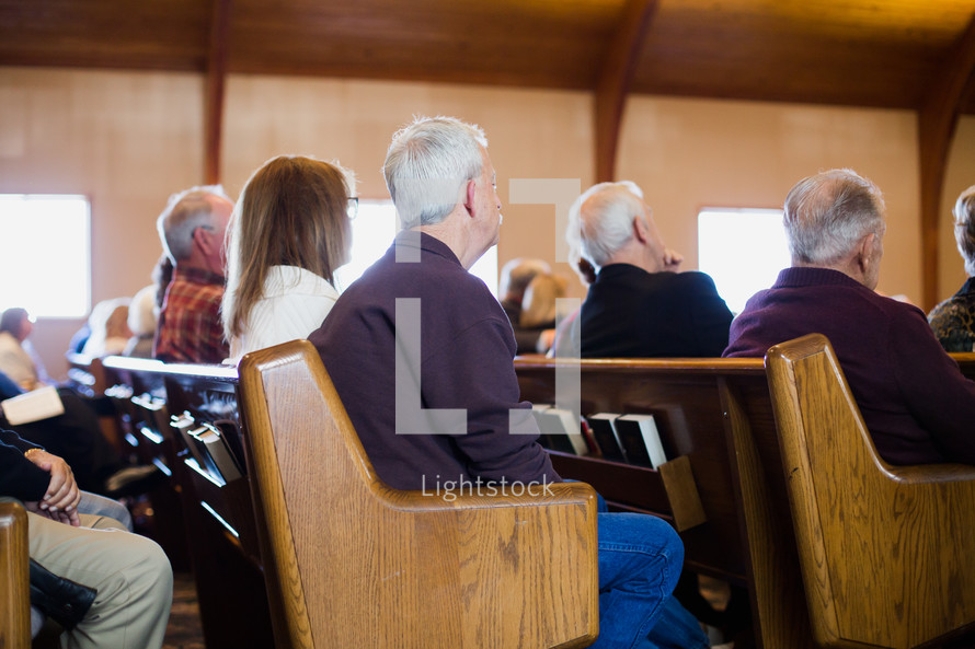 congregation sitting in church pews 
