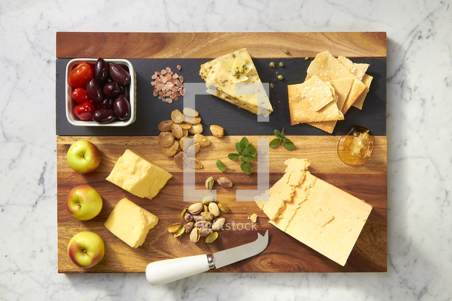 Cheese and fruit on a wood cutting board 
