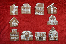 frame out of different self baked gingerbread houses on red with copy space in the middle as part of a advent calendar