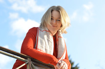 a woman standing looking over a railing 